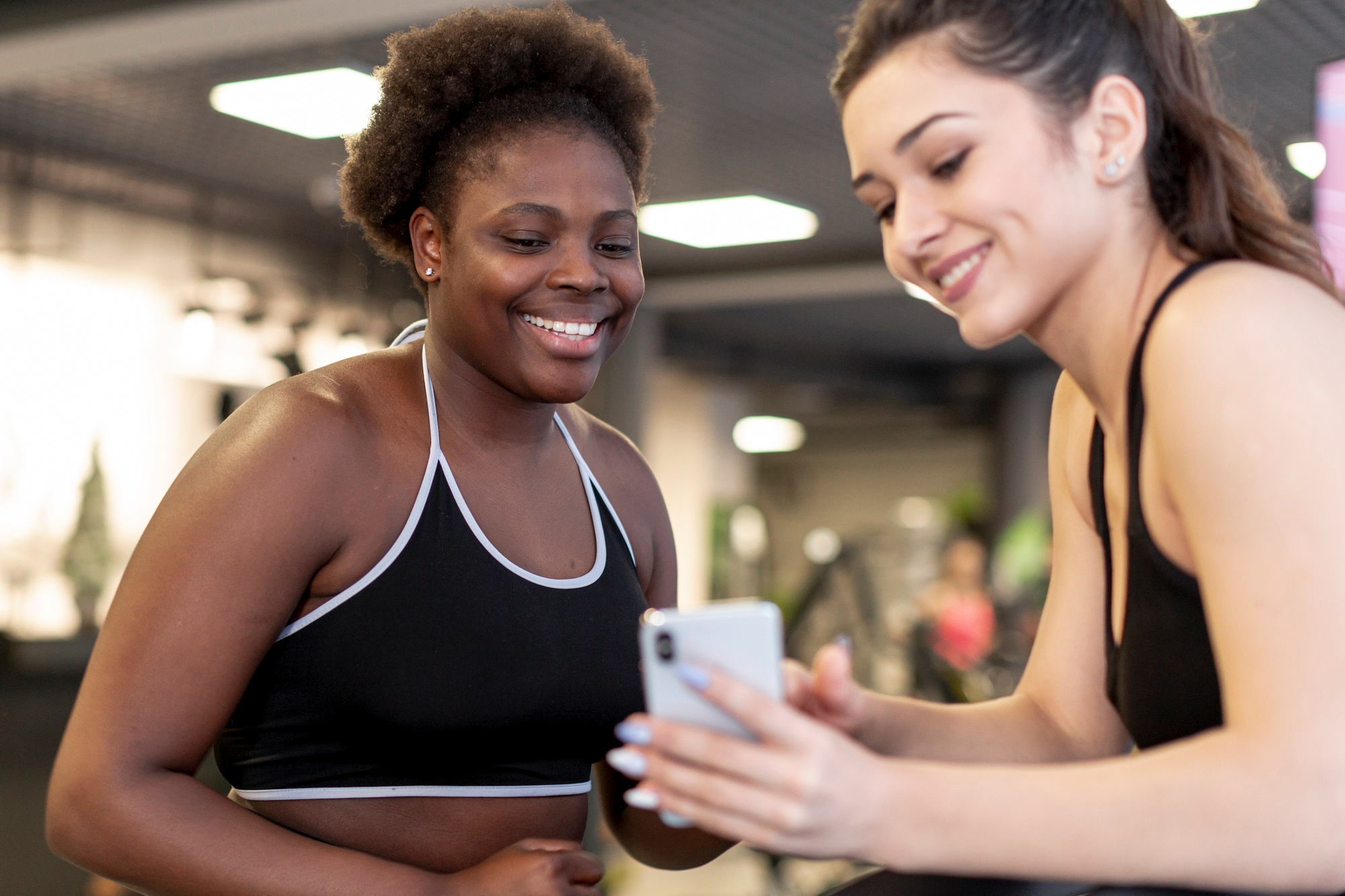 Two women looking at wellness data on a phone