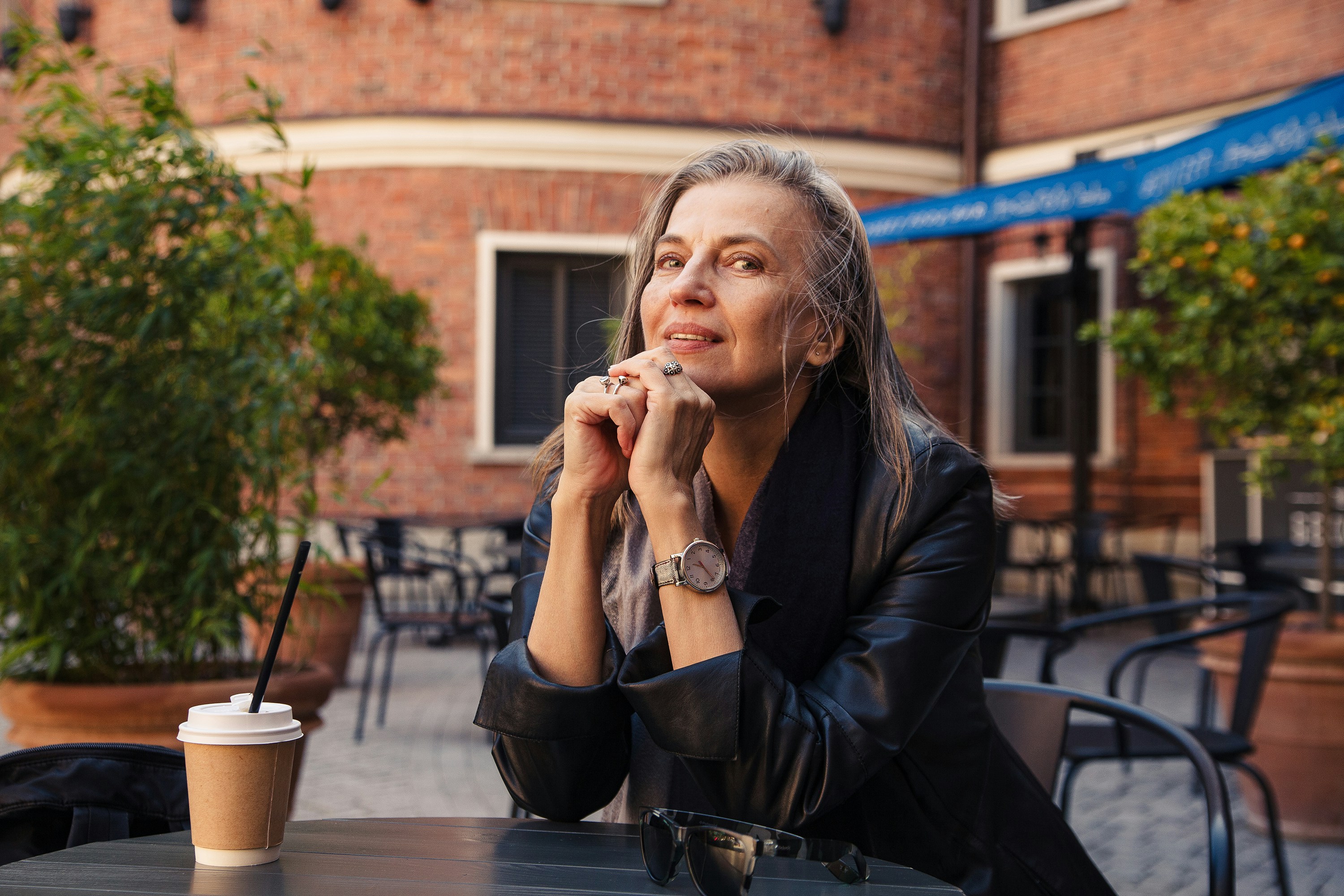 Woman at a café, reflecting